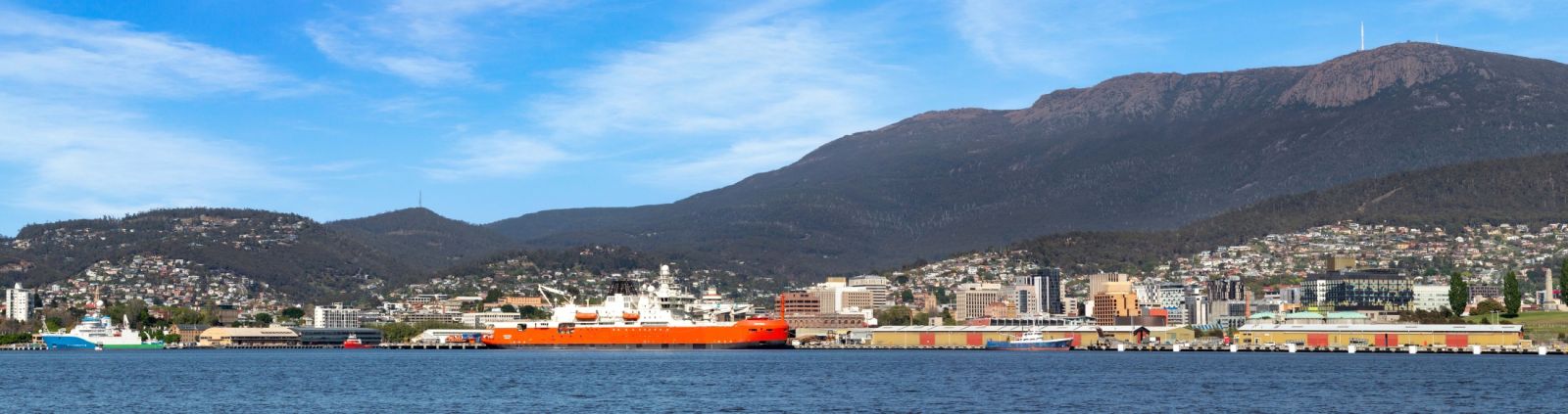 Australian icebreaker Nuyina docked at Hobart on a clear, blue sky day